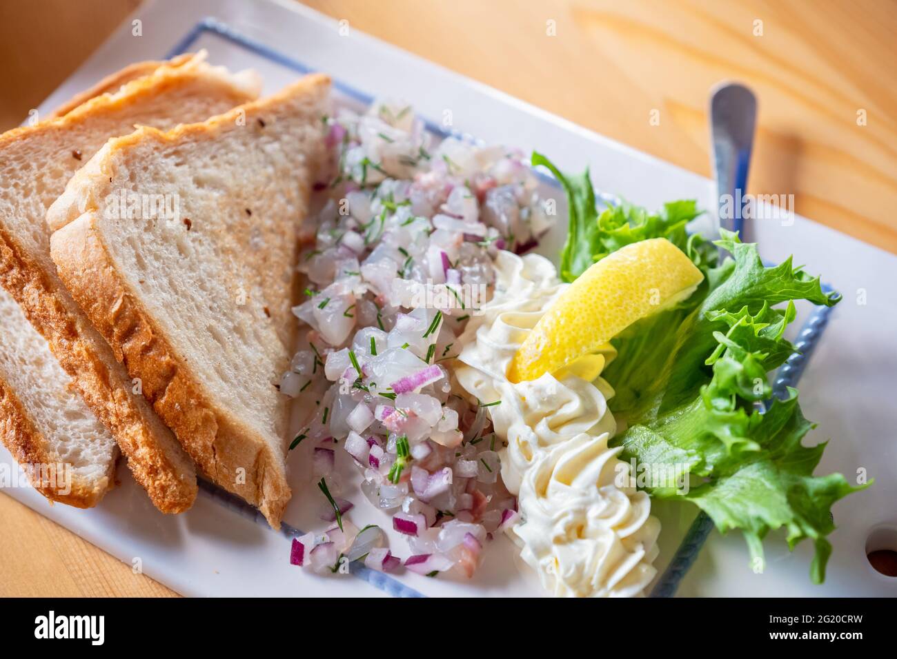 Pike perch tartare with onion and bread toast Stock Photo