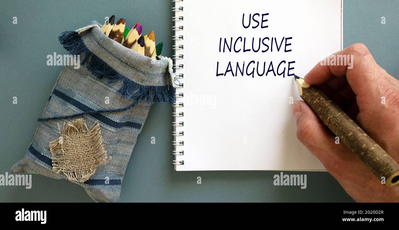Language Inuse Use inclusive language symbol. Businessman writing concept words 'Use ...