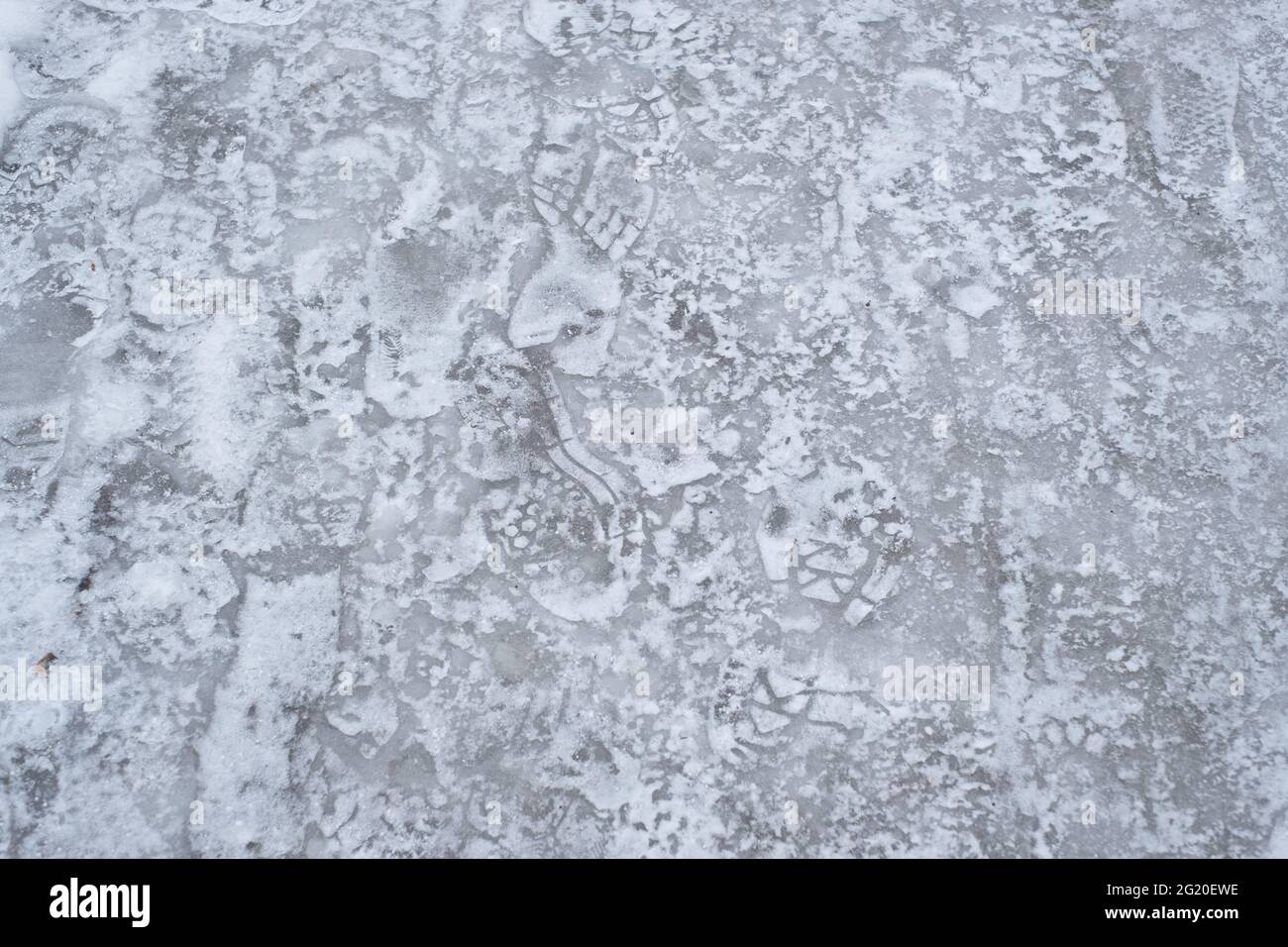 Slippery frozen road covered with ice during winter. Difficult weather conditions. Stock Photo