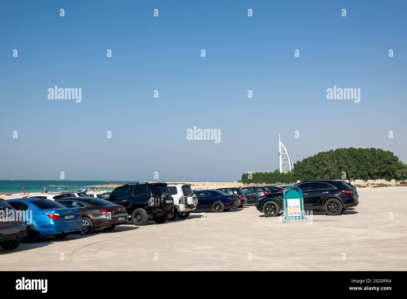 Cars parked on one of the few public beaches in Dubai, UAE. Stock Photo