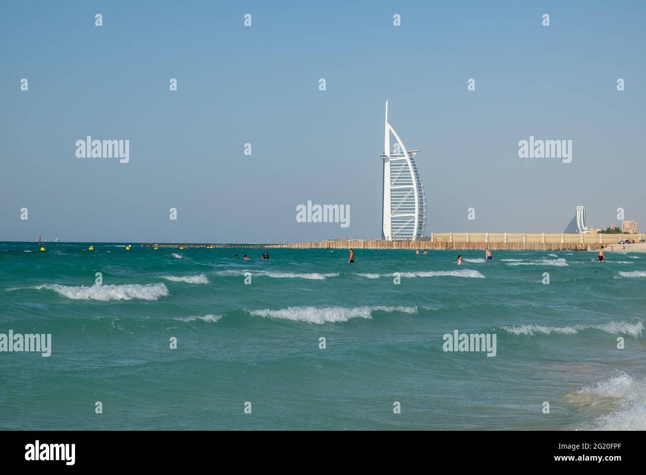 The white sail of Burj Al Arab seems to be floating in the sea. Dubai, UAE. Stock Photo