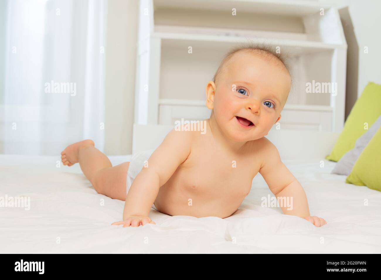 Smiling little baby lay on the belly and laugh Stock Photo Alamy