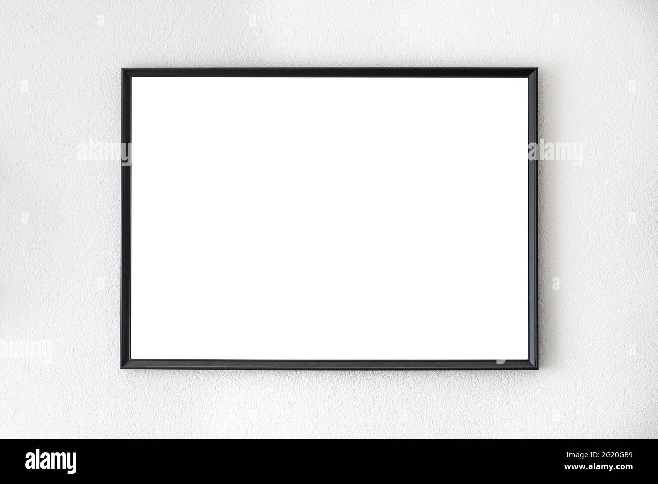 Mockup frame in black hanging on a white wall Stock Photo