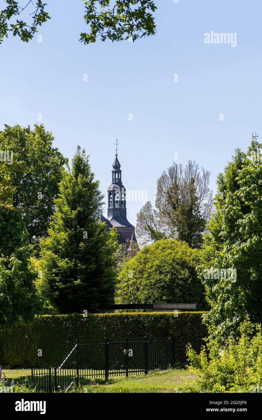 Tower of the Oude Calixtus church in Groenlo, a city in the municipality of Oost Gelre, between the trees Stock Photo