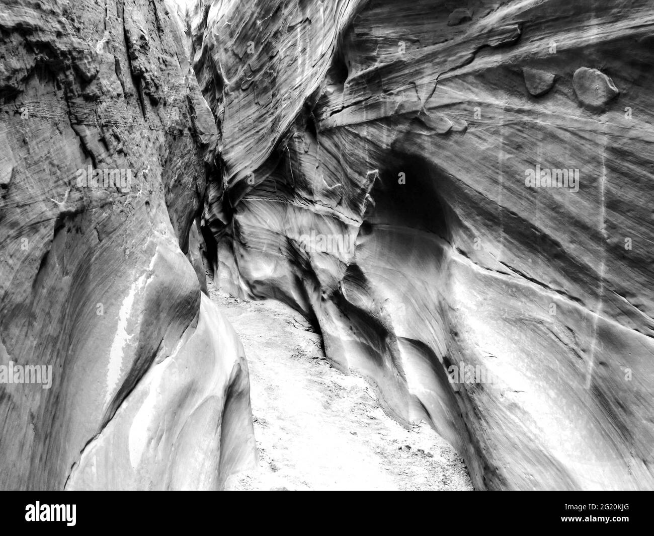 Cross-bedding on the steep cliffs of the Dry Fork slot canyon in in the Grand Staircase-Escalante National Monument, Utah, USA in black and white Stock Photo