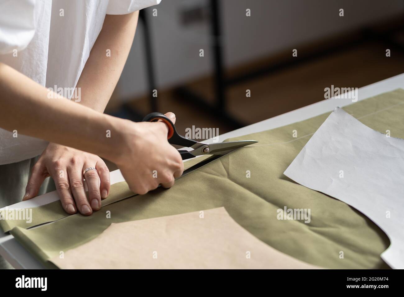 Dressmaker cut pattern in tailor closeup of designer woman