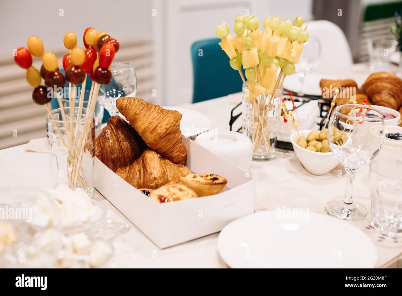 Party catering. Festive dinner table setting with canapes, croissants ...