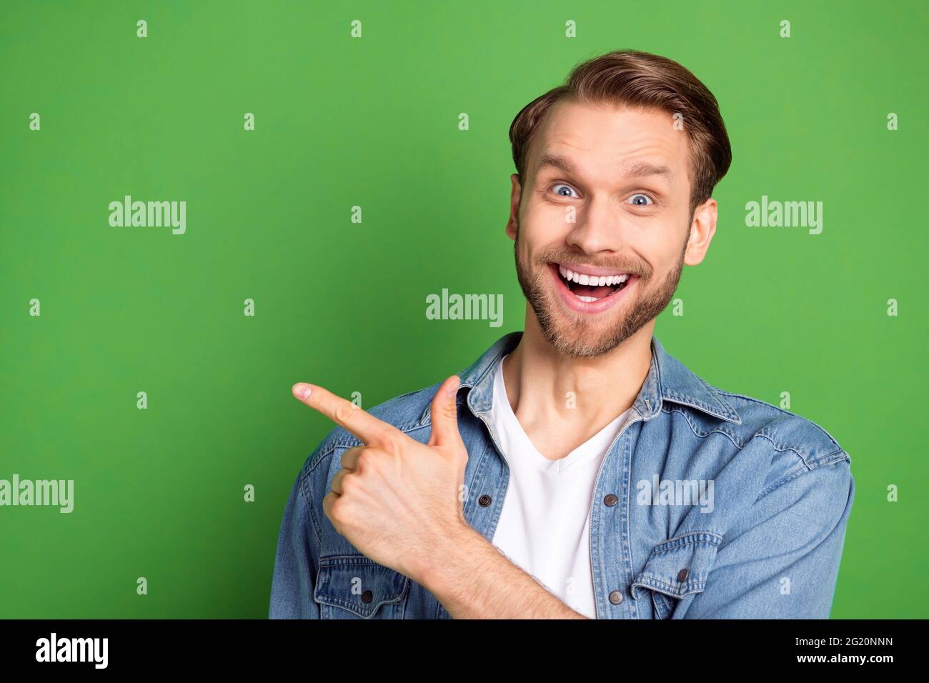 Photo portrait of amazed guy pointing blank space surprised smiling ...