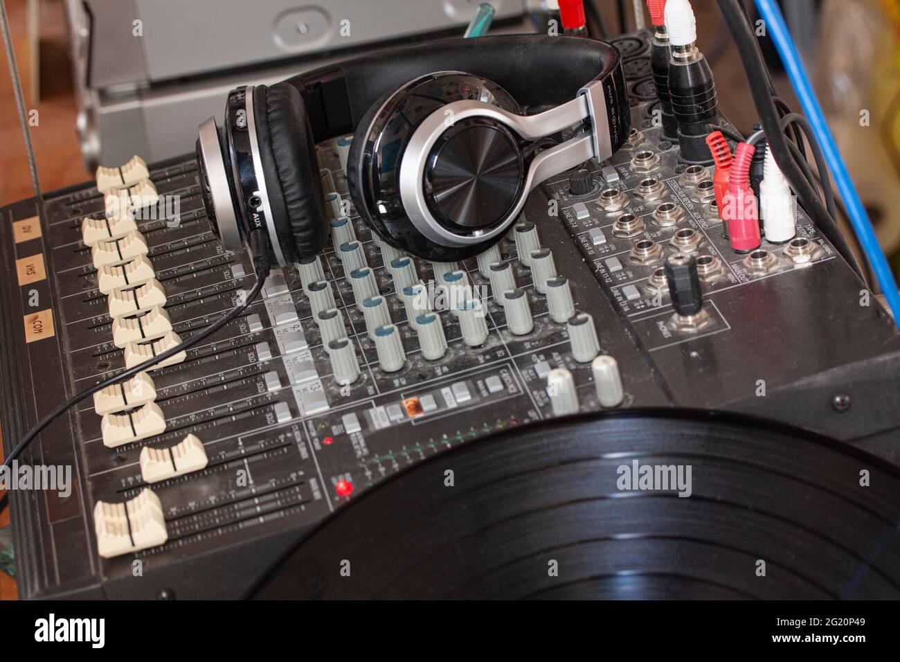 Old fashioned music sound mixer with headphones. Professional audio