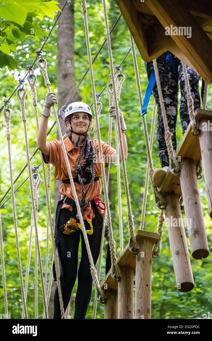 Young women enjoying the Screaming Eagle Aerial Adventures ziplines and high ropes course at Chattahoochee Nature Center in Roswell, Georgia. (USA) Stock Photo