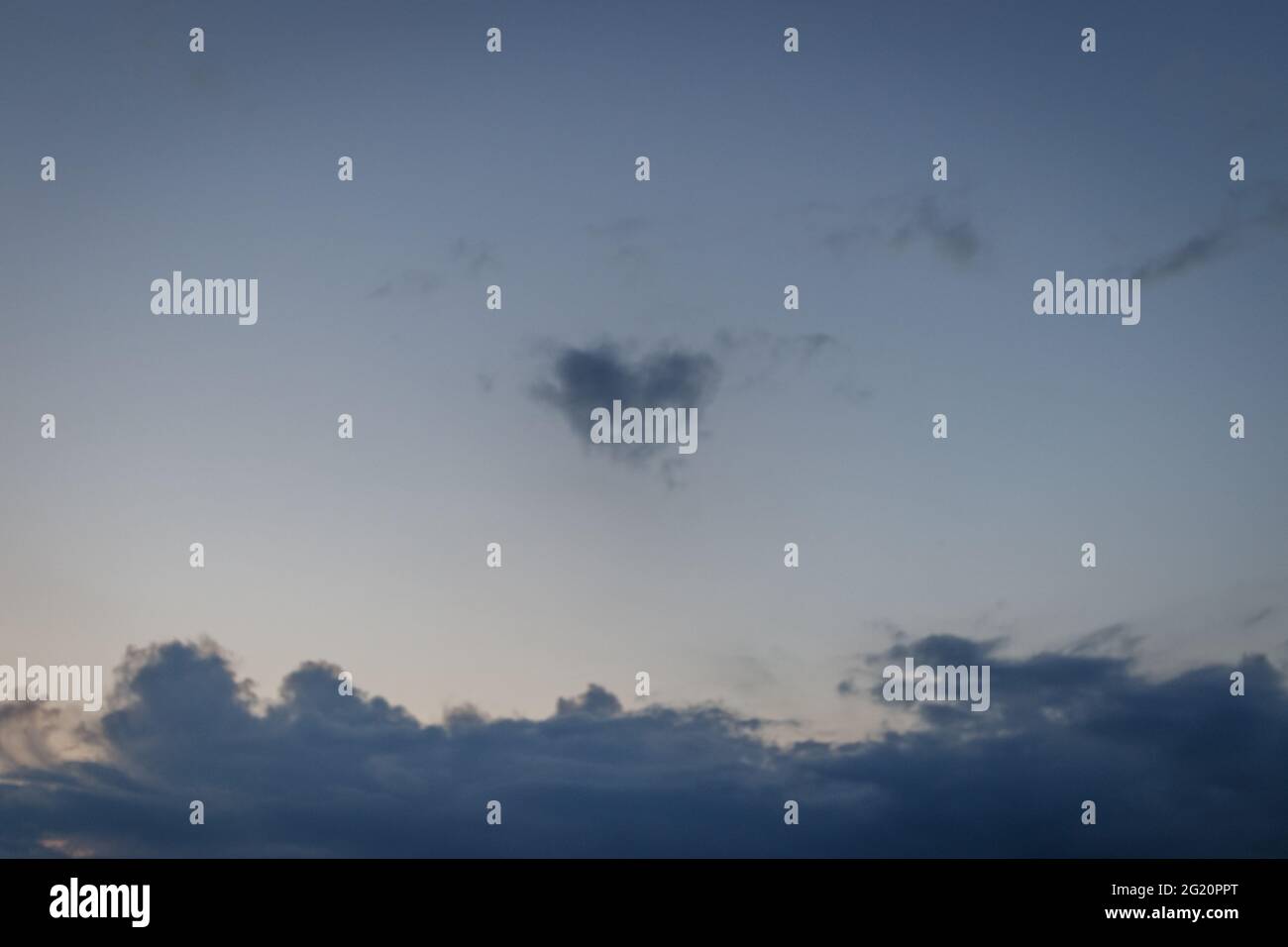Beautiful scenery of the sunset sky with fluffy clouds Stock Photo - Alamy