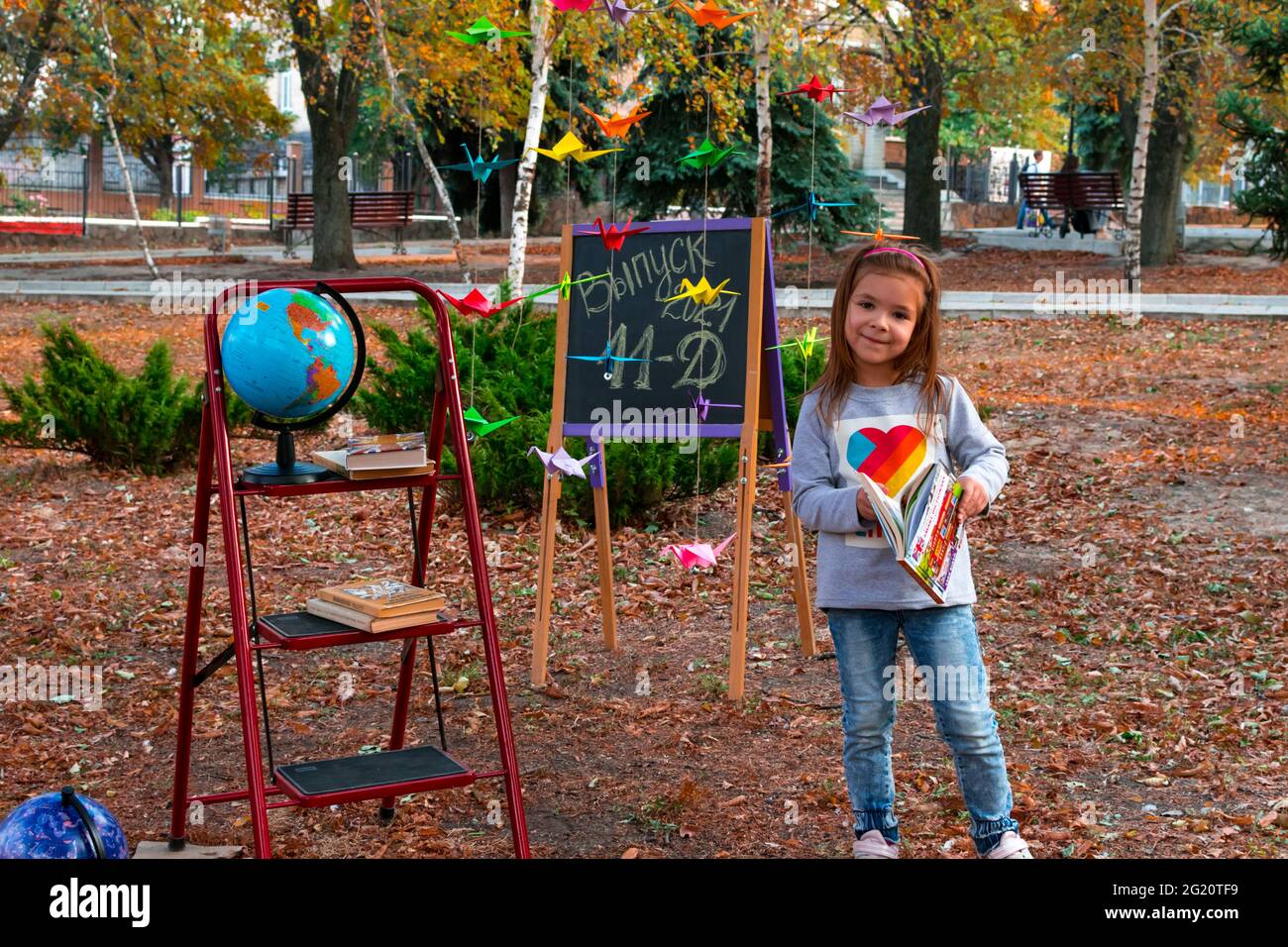 Lysychansk. Ukraine 10.04.2020. Issue 2021 11 D. Adorable little schoolgirl against the background of an autumn park against the background of a Stock Photo