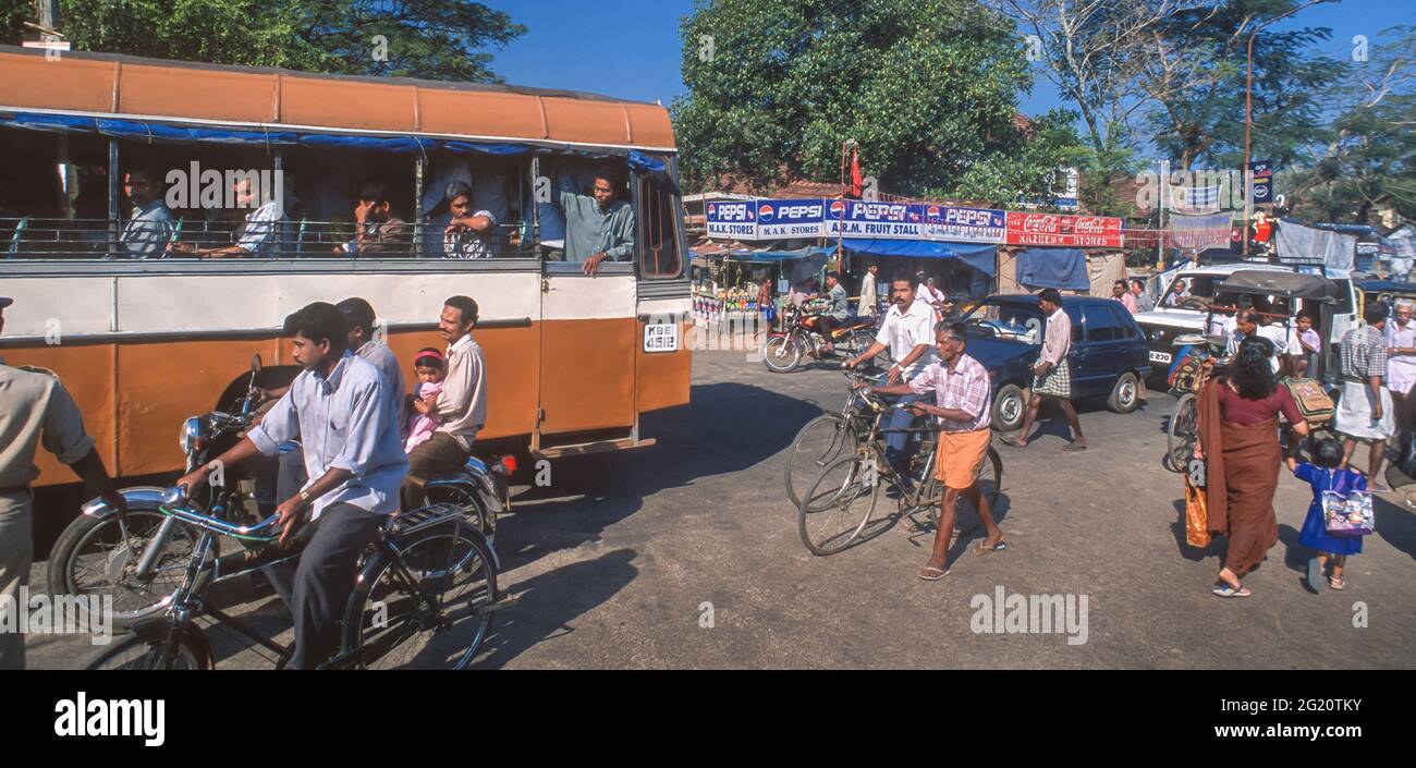 ALLEPPEY, KERALA, INDIA - Street scene with people, bicycles and bus ...