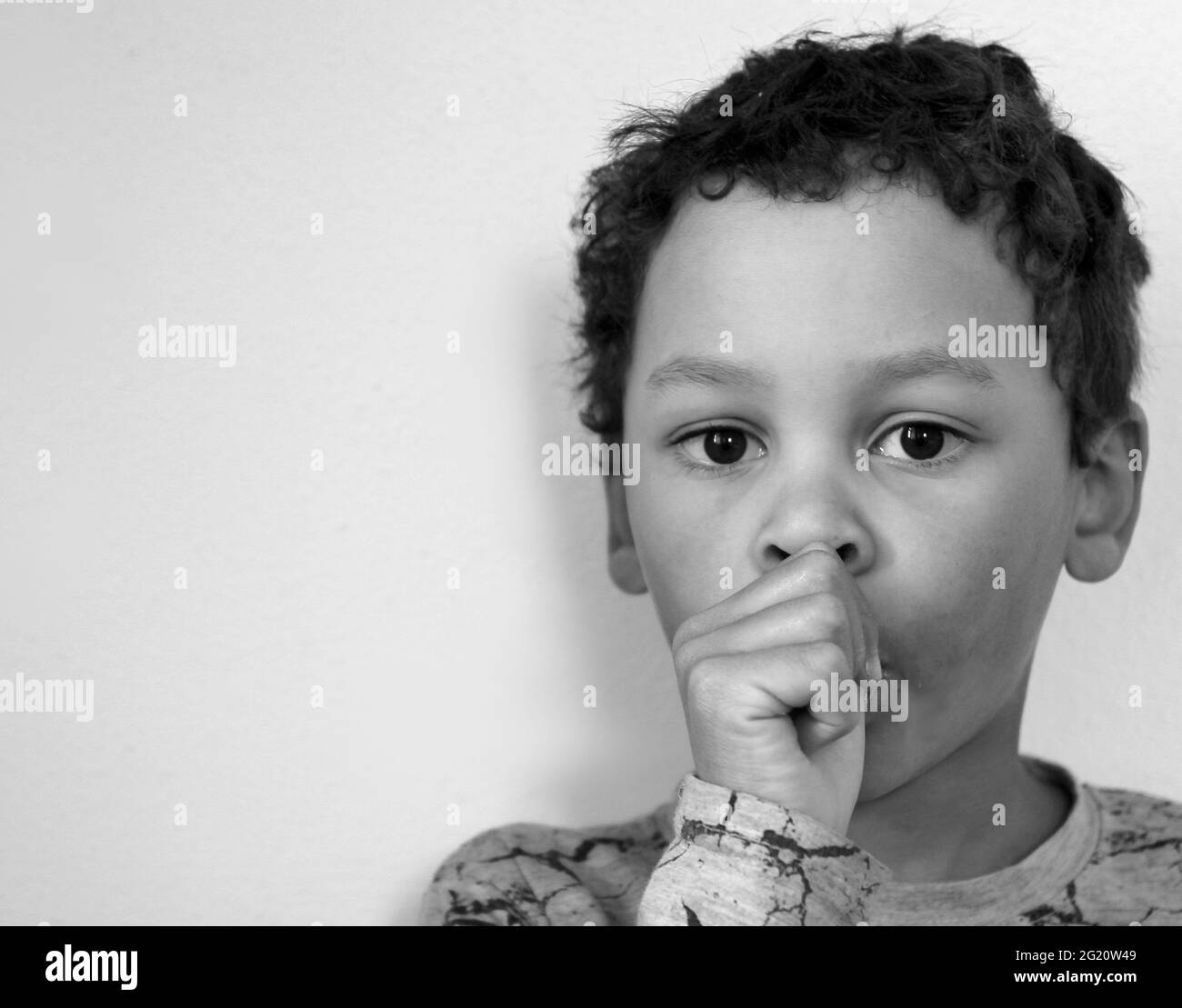 boy sucking thumb on white background stock photo Stock Photo