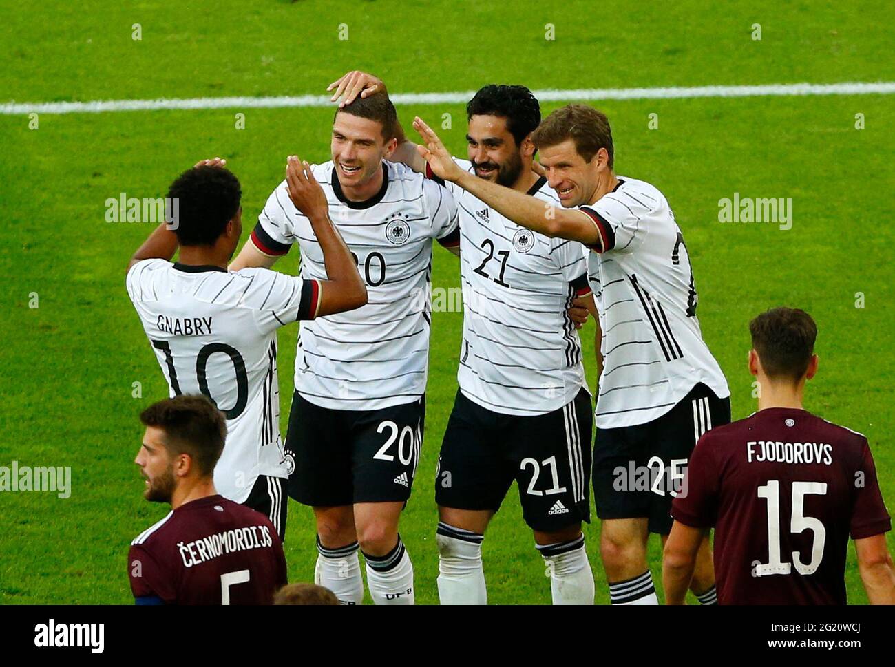 Germany's Ilkay Gundogan celebrates with teammates Germany's Thomas Mueller  and Germany's Serge Gnabry after scoring his side's first goal during the  World Cup group E soccer match between Germany and Japan, at