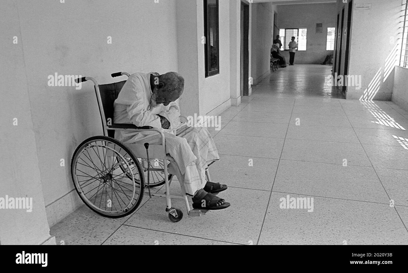 A physically challenged man on a wheelchair. Dhaka. Stock Photo
