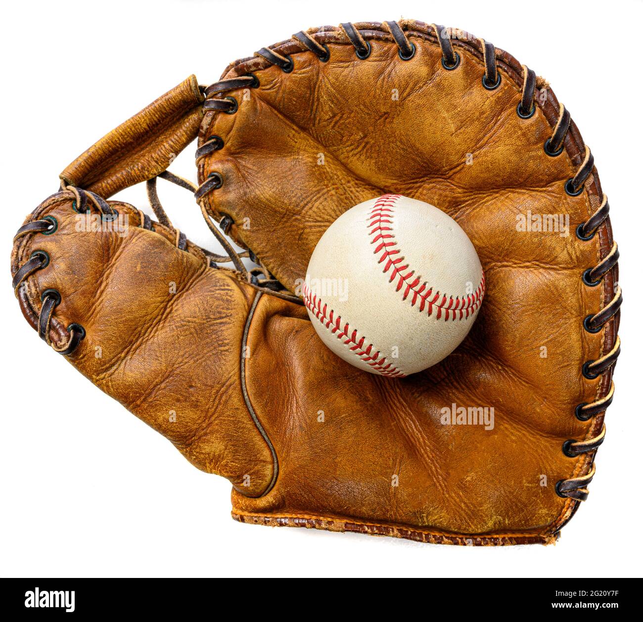 A white leather baseball in a brown vintage, antique glove Stock Photo