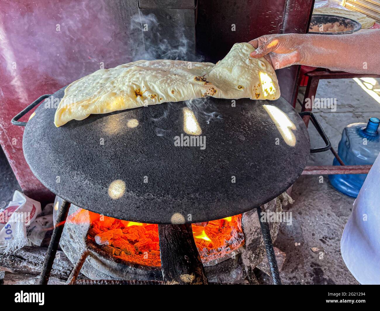 https://c8.alamy.com/comp/2G21294/flour-tortillas-cooked-on-a-steel-comal-with-the-fire-of-the-mesquite-wood-embers-at-the-burros-de-carne-asada-stalls-in-the-tiaguis-del-hectro-espino-sonoran-food-on-the-embers-food-food-meals-food-photo-by-luis-gutierrez-norte-photo-tortillas-de-harina-cocida-en-comal-de-acero-con-el-fuego-de-las-brasas-de-lea-de-mezquite-en-los-puestos-de-burros-de-carne-asada-en-el-tiaguis-del-hectro-espino-comida-sonorense-en-las-brasas-alimentos-comida-comidas-food-photo-by-luis-gutierrez-norte-photo-2G21294.jpg