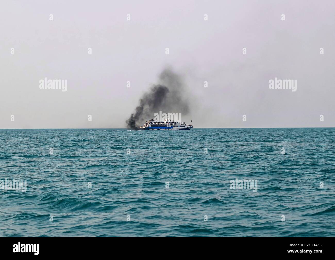 Ferry boat of Bay of Bengal smoke coming from its chimney. Black exhaust fumes coming from the chimney of a moored tanker after main engine ignition. Stock Photo
