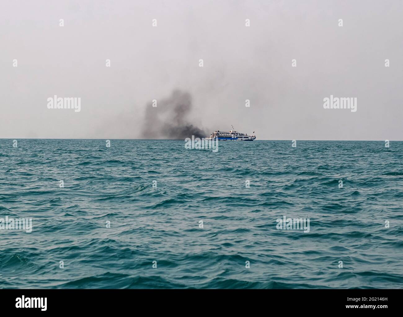 Ferry boat of Bay of Bengal smoke coming from its chimney. Black