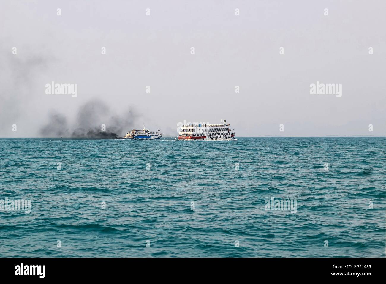 Ferry boat of Bay of Bengal smoke coming from its chimney. Black exhaust fumes coming from the chimney of a moored tanker after main engine ignition. Stock Photo