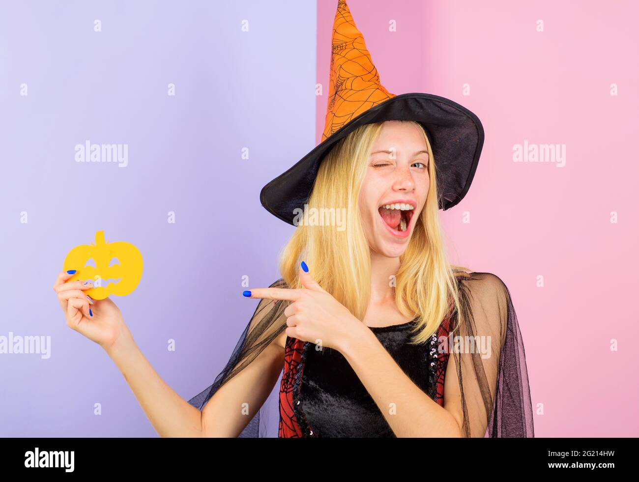Happy Halloween. Winking woman with paper pumpkin. Trick or treat. 31 October. Stock Photo