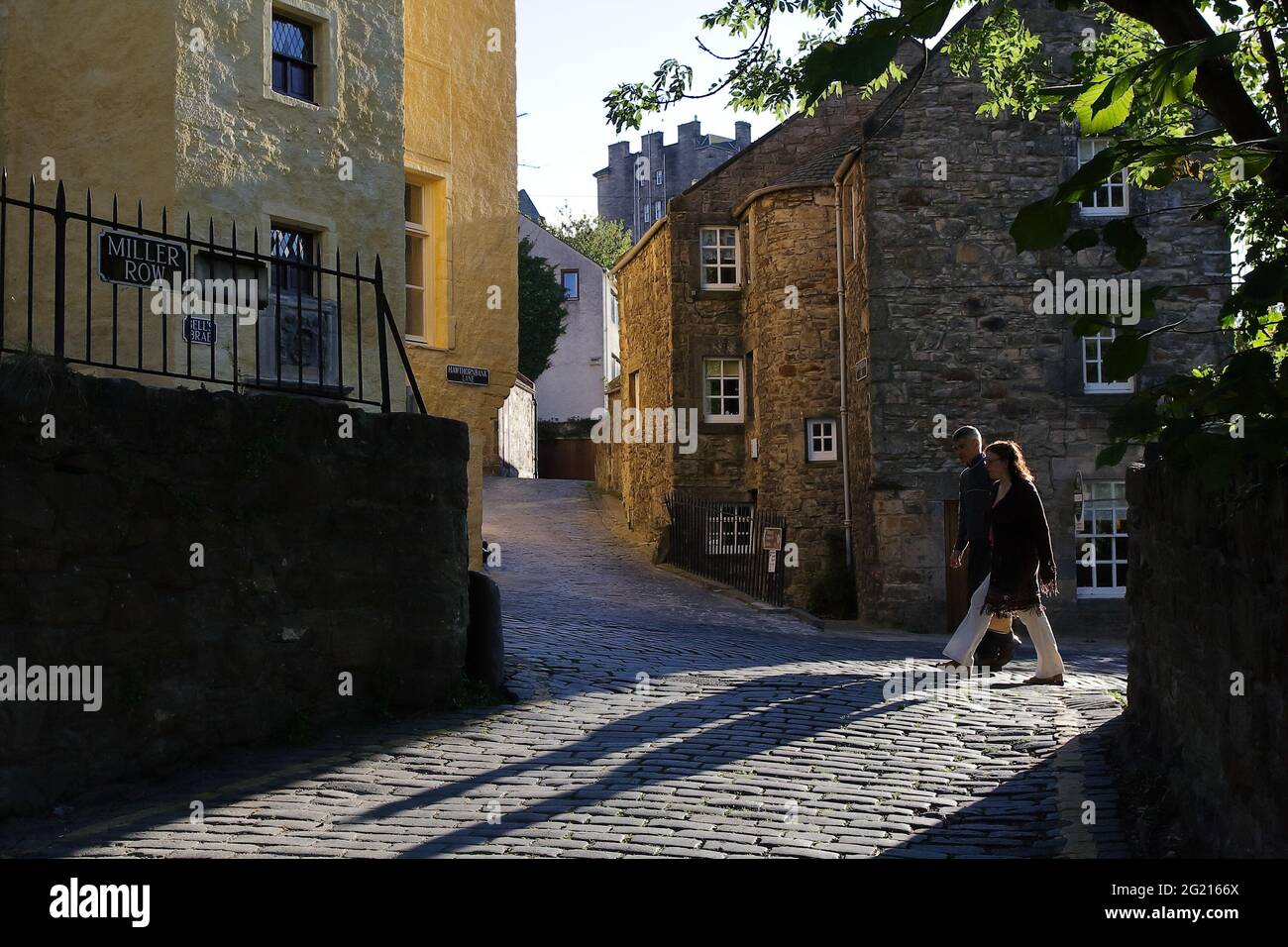 Colors and soft light reflections emphasizing the texture on the walls of the historical buildings along the creek walking route Stock Photo