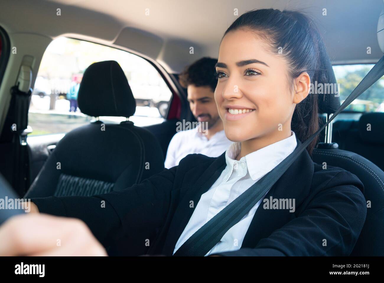 Taxi driver with passenger at back seat Stock Photo Alamy