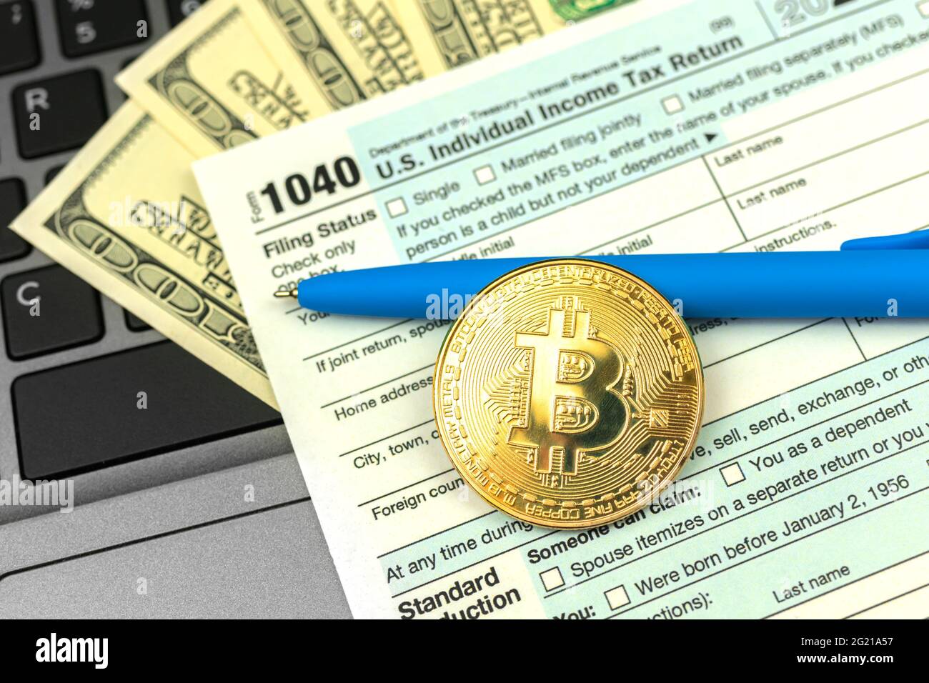 Paying the taxes by crypto currency, 1040 US Individual Income Tax Return  from next to bitcoin coin Stock Photo - Alamy