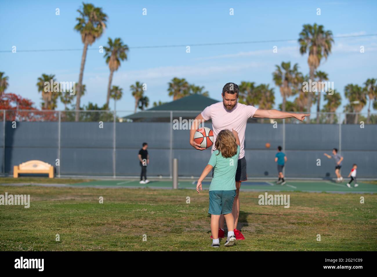 Boy child listen to man trainer explaining basketball rules on sports