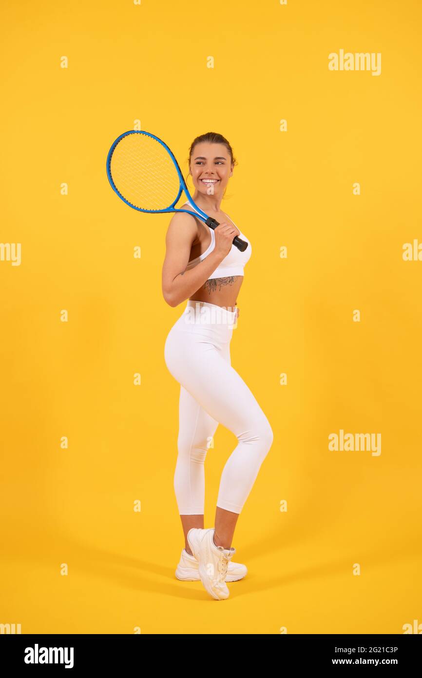 sporty woman tennis player with fit body in sportswear hold badminton racket, sport. Stock Photo