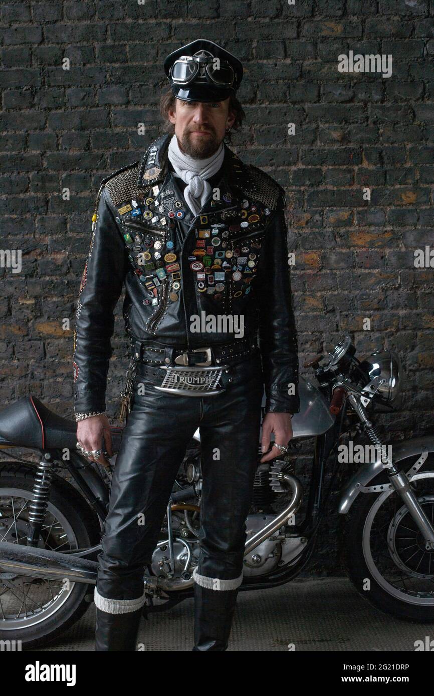 Rocker in cafe racer gear wearing black leather jacket covered in studs ...