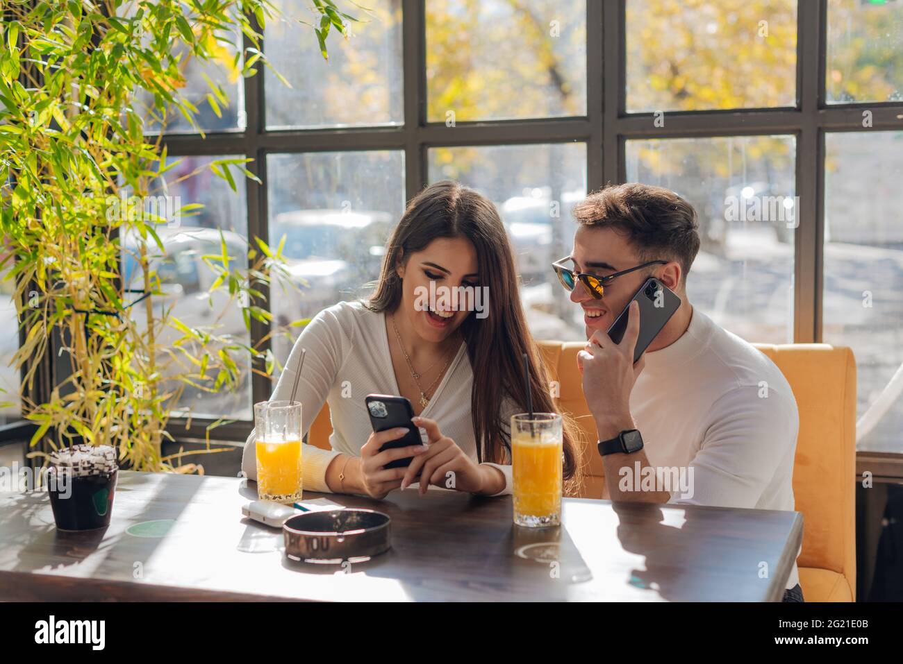 Friends socializing, having fun, and laughing drinking coffee in