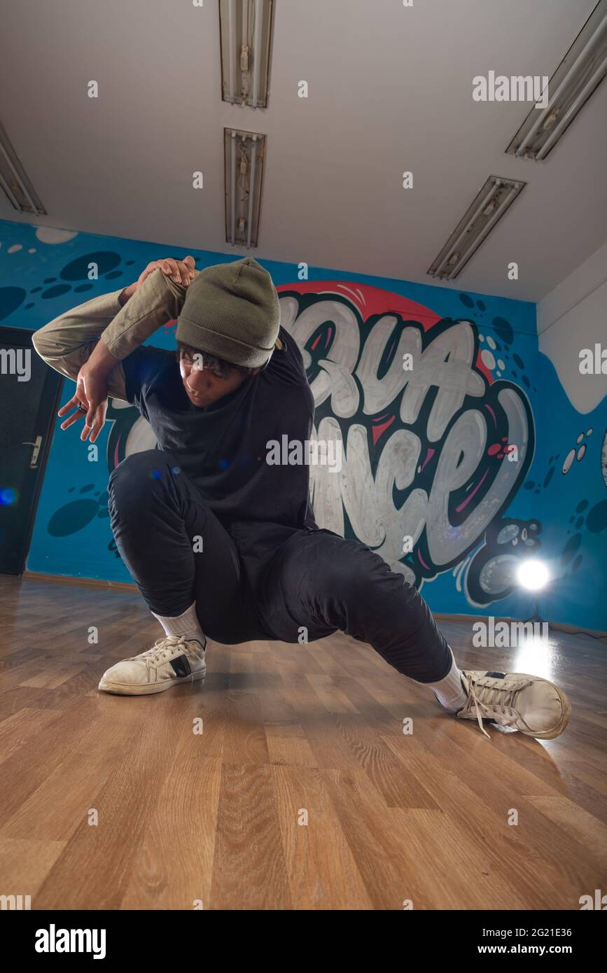 English Rapper Dancing Modern rapper dancing in garage. Urban lifestyle, hip hop Stock Photo ...