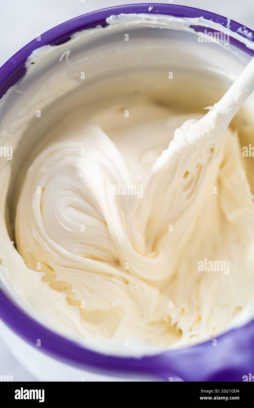 Melting storebought buttercream frosting in candy melting pot to glaze