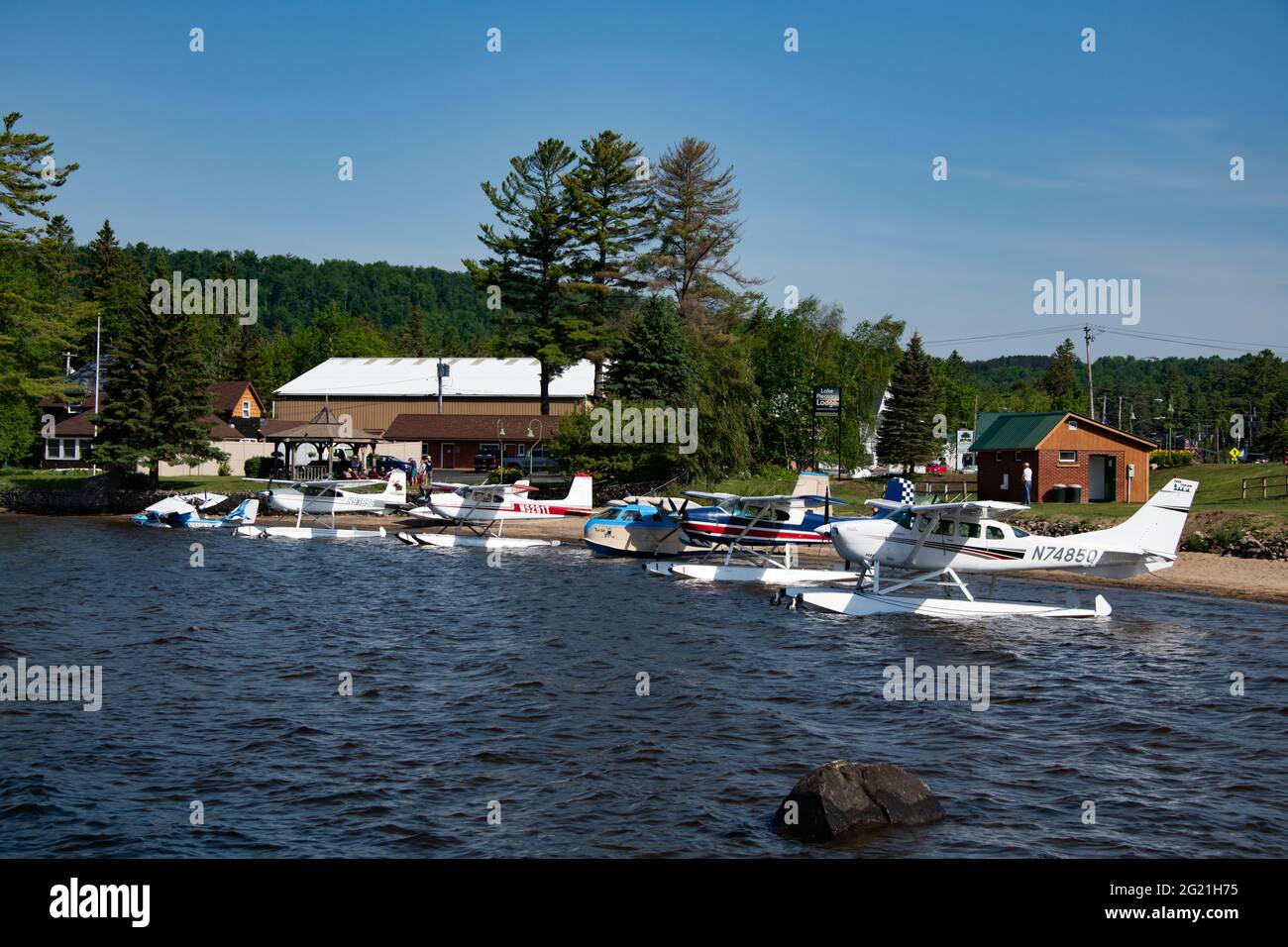 A group of seaplanes and float planes on the public beach in Speculator