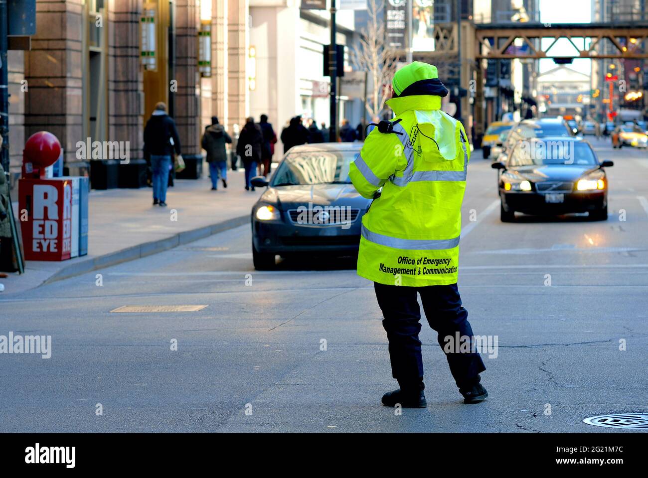 A City of Chicago Office of Emergency Management and Communications worker observes traffic on a busy downtown street in Chicago, Illinois, USA. Stock Photo