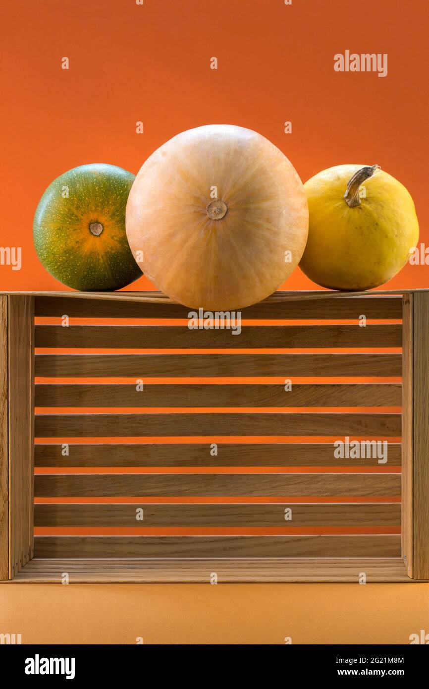Still life with round pumpkins on a wooden box Stock Photo