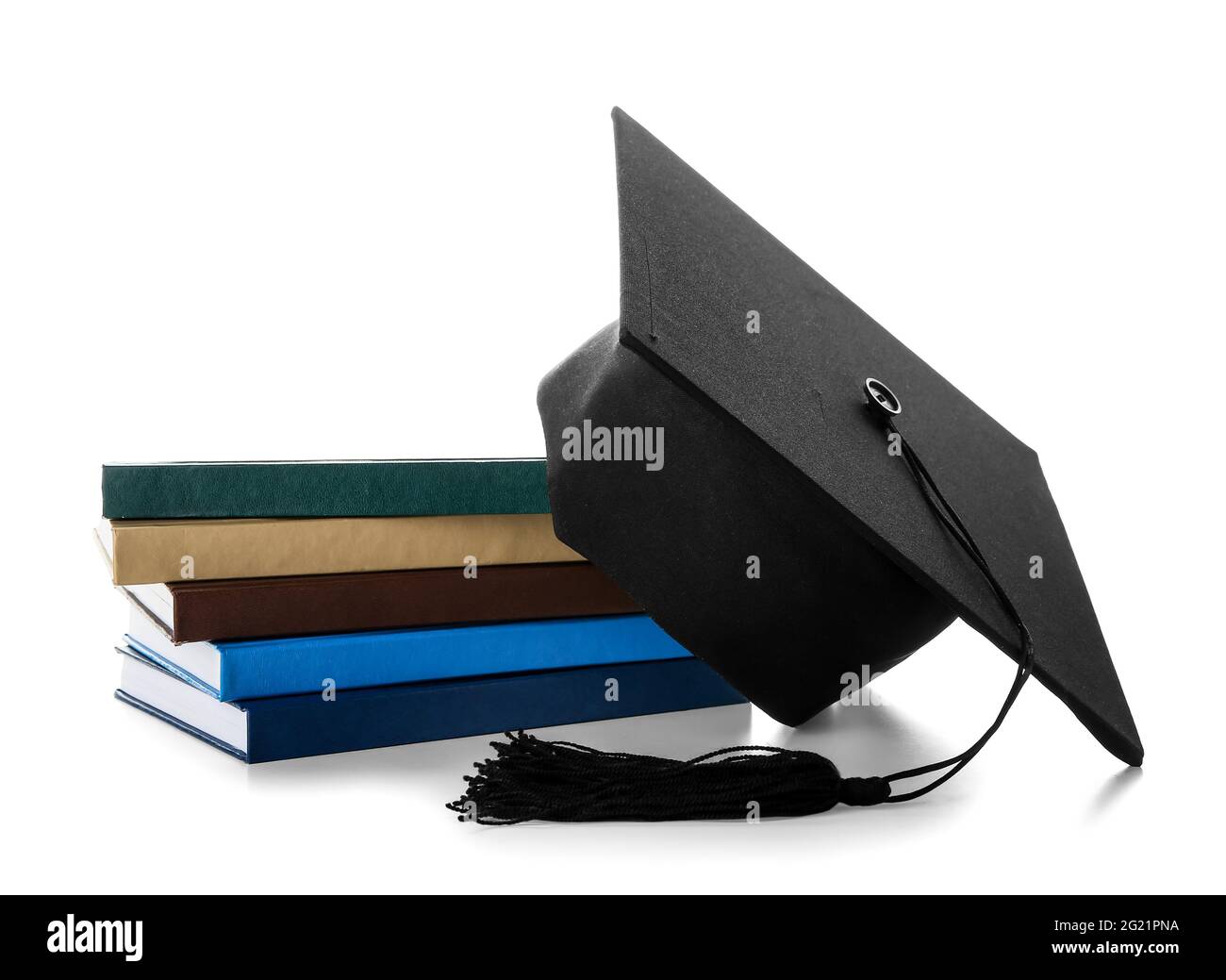 Graduation hat with books on white background Stock Photo - Alamy