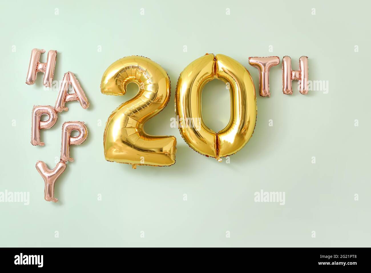 Text HAPPY 20TH made of air balloons on color background Stock Photo