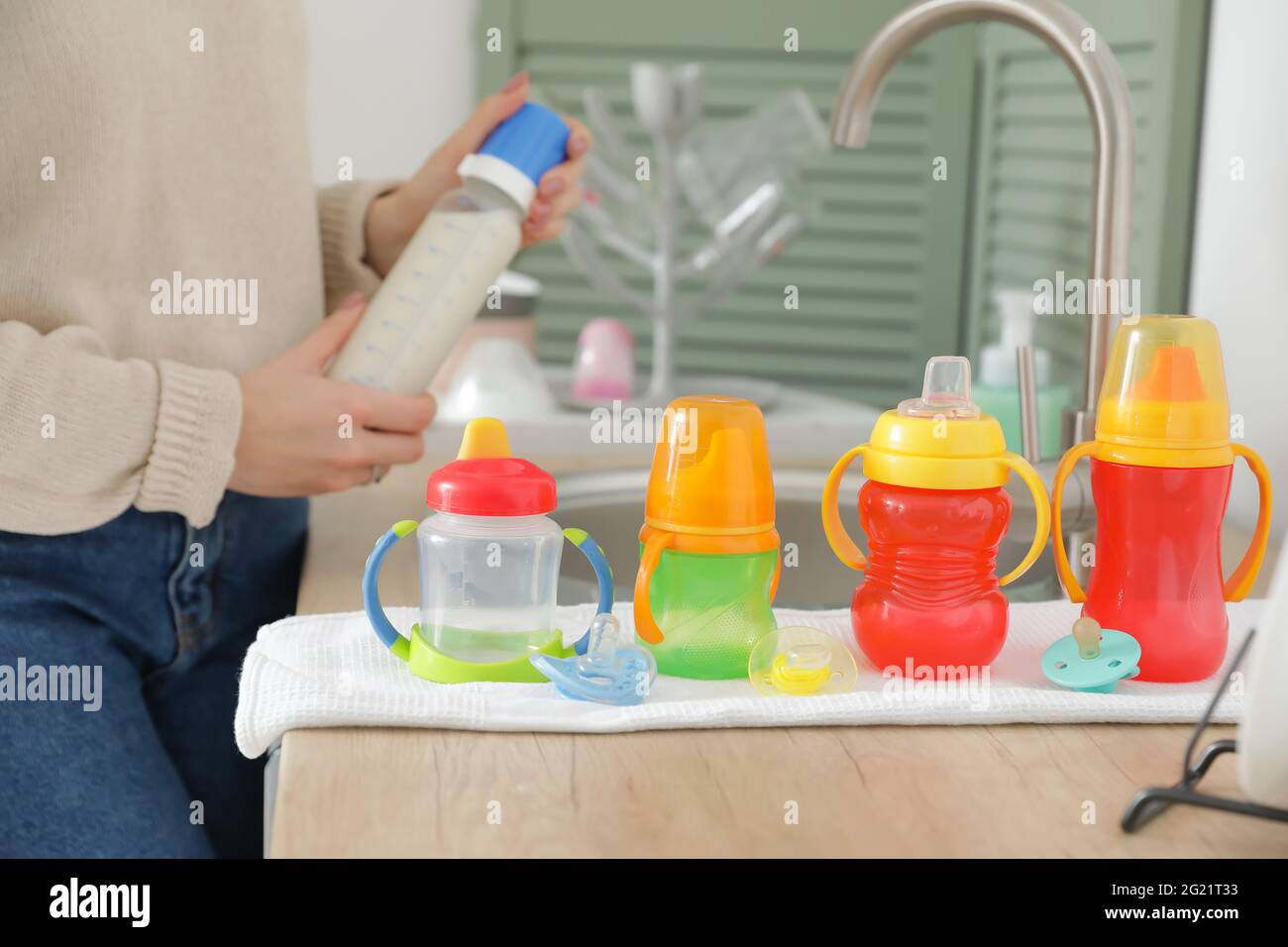 https://c8.alamy.com/comp/2G21T33/clean-baby-bottles-on-table-near-sink-2G21T33.jpg