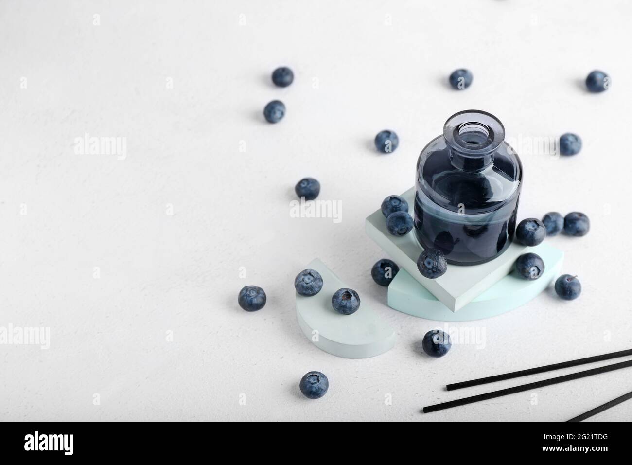 Reed diffuser with blueberries on white background Stock Photo