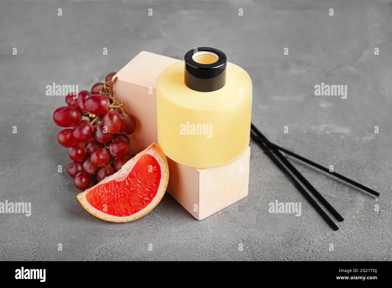Reed diffuser with fruits on grunge background Stock Photo