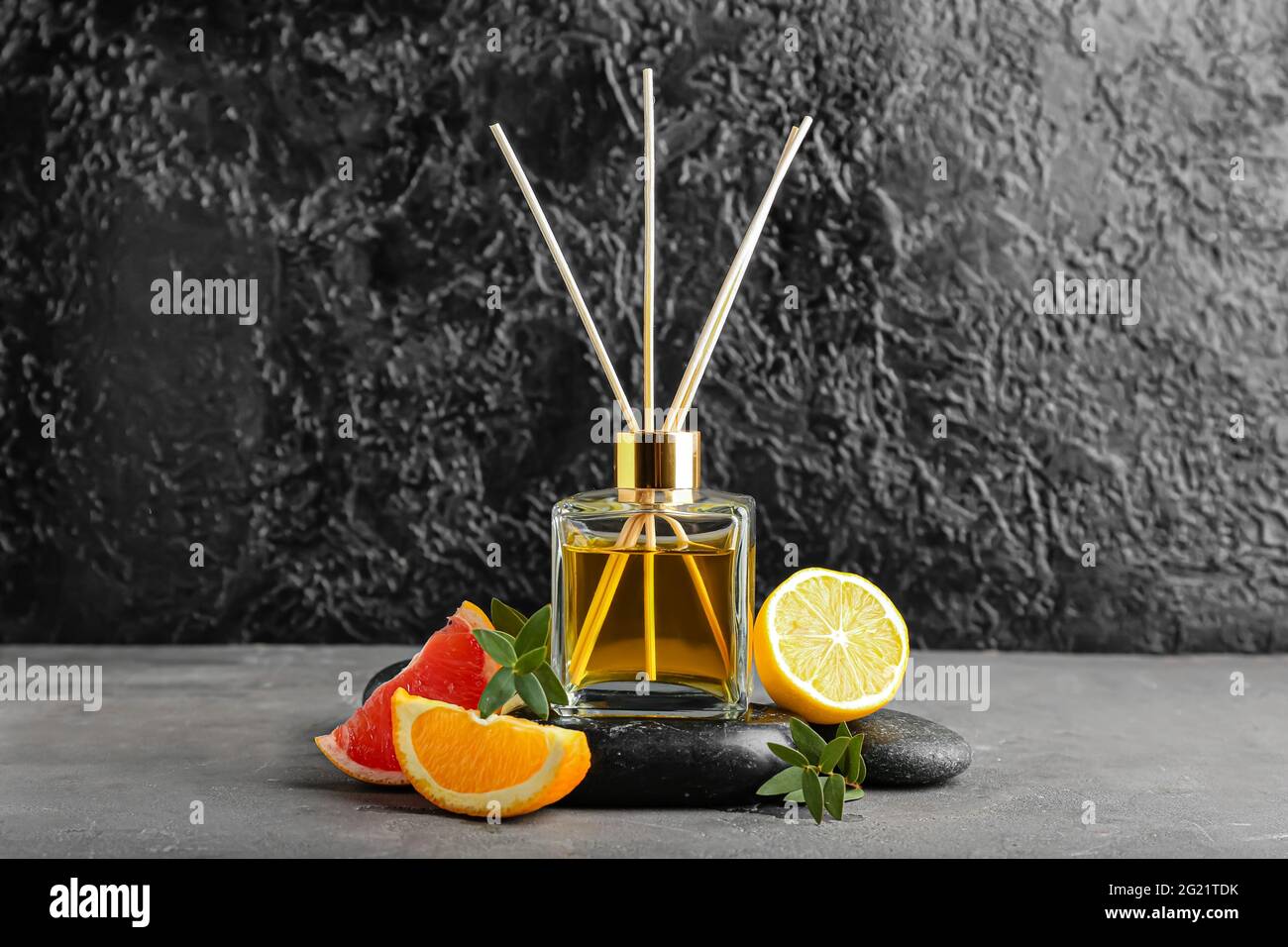 Citrus reed diffuser on dark background Stock Photo