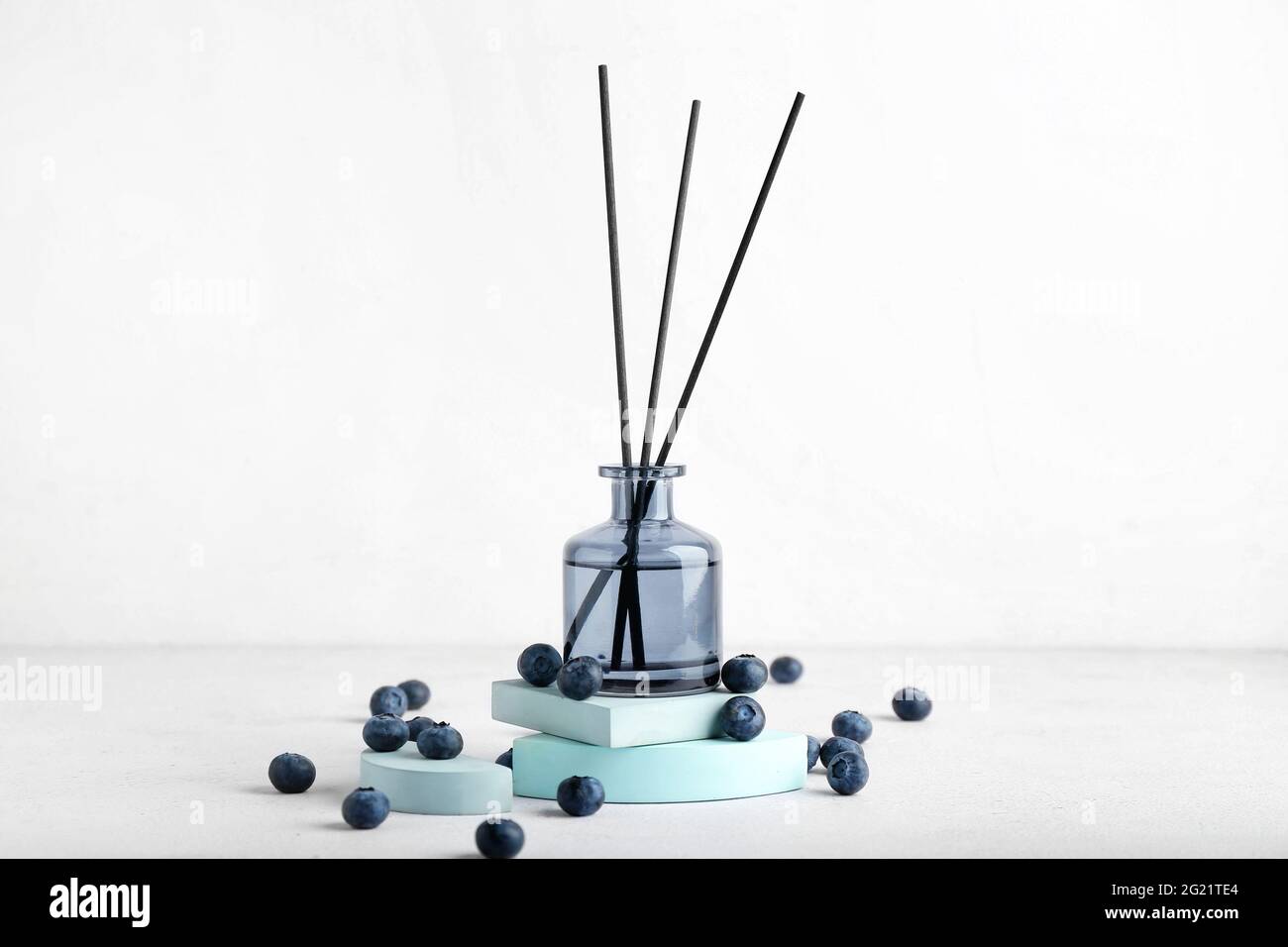 Reed diffuser with blueberries on white background Stock Photo