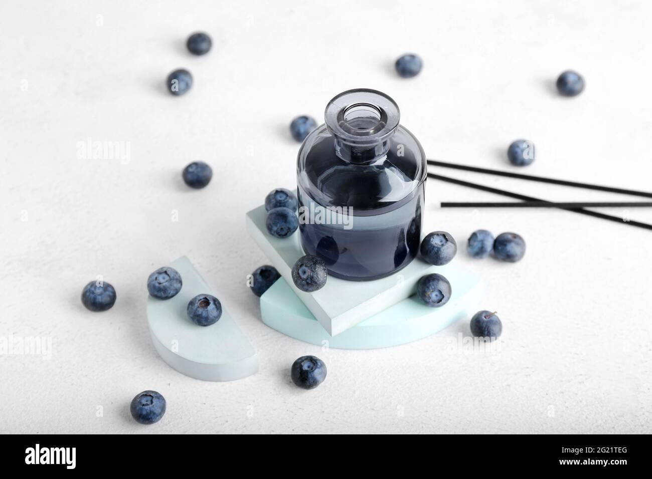 Reed diffuser with blueberries on white background Stock Photo