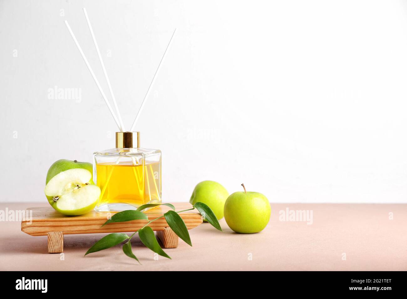 Reed diffuser with apples on table Stock Photo
