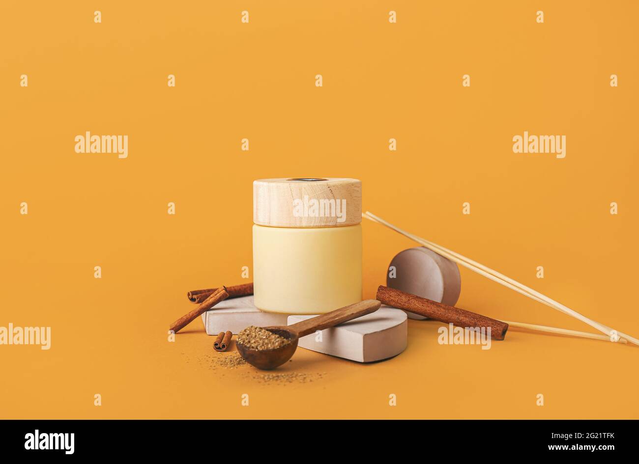 Reed diffuser with cinnamon on color background Stock Photo