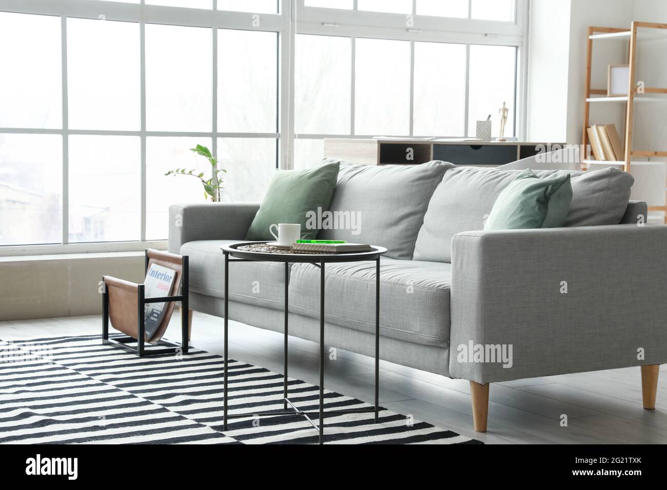 Stylish interior of living room with comfortable sofa Stock Photo - Alamy