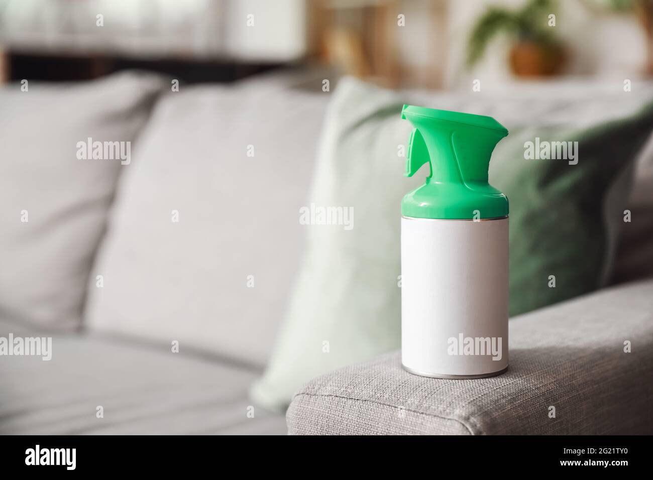 Bottle of air freshener on sofa in room, closeup Stock Photo Alamy